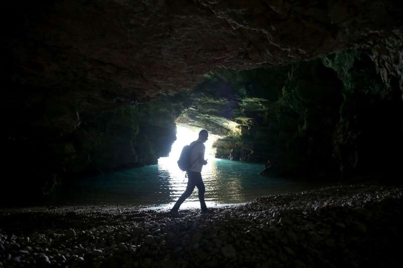 Albanian biodiversity expert Nexhip Hysolokaj in one of the sea caves the rare seals hang out in