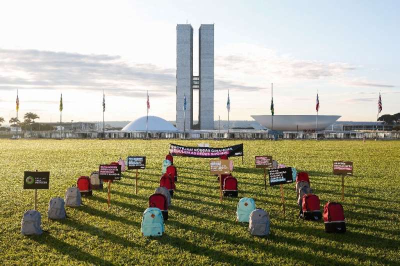 Backpacks representing victims of school massacres, which activists say have increased in Brazil amid lack of regulation of extr