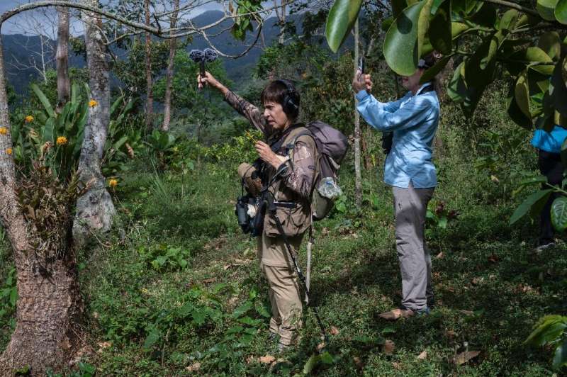 Bird guide Rosaelena Albornoz (L) records bird songs as other birdwatchers identify species for the Global Big Day