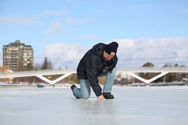 Bruce Devine, senior manager facilities and programs at the National Capital Commission checks the ice condition on the Rideau C
