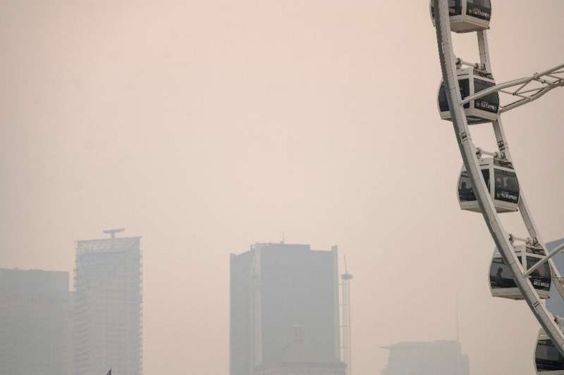 Buildings at Montreal's old port are barely visible through the wildfire smoke