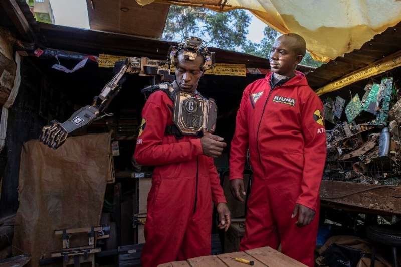 David Gathu, left, and Moses Kiuna are self-taught Kenyan innovators who have built a bio-robotic prosthetic arm out of electron