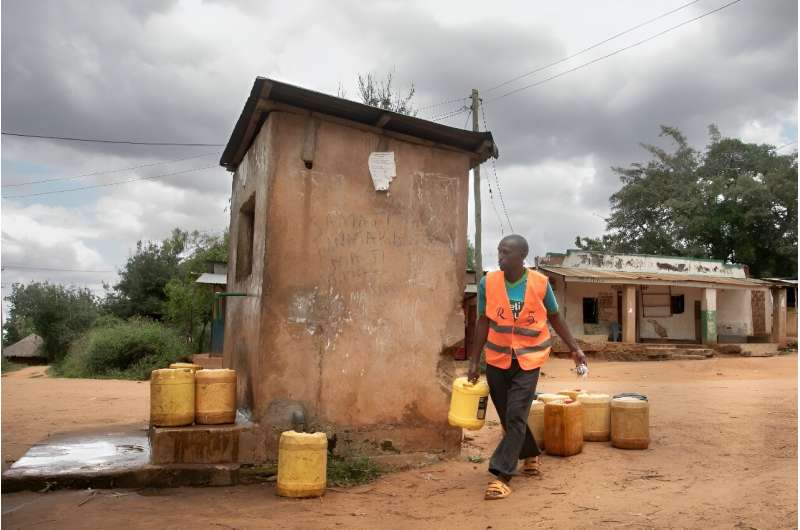 Dominic Mwakai, 43, sells water collected from  natural springs flowing from Mount Kasigau