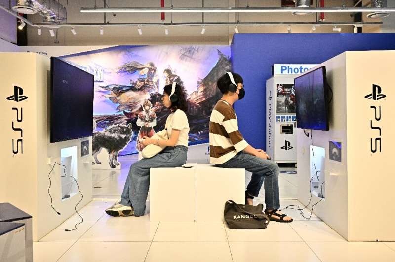 Eager gamers play Final Fantasy XVI in a Seoul store