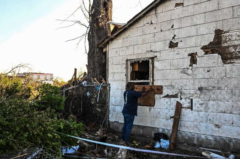 Eddie Jones repairs a window on his damaged house in Rolling Fork, Mississippi, after the area was hit by a tornado