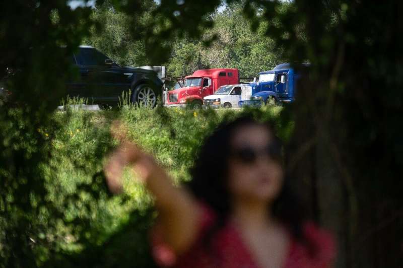 Erandi Trevino stands outside her home, located next to a parking lot where trucks park and idle in Houston, Texas on June 27, 2
