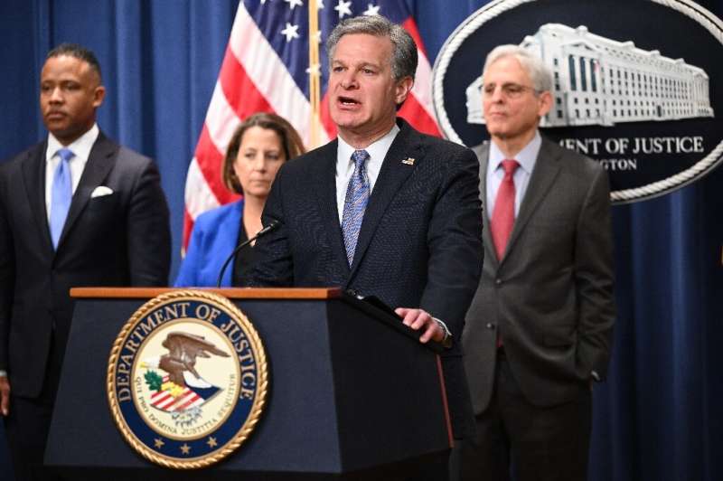 FBI Director Christopher Wray with Deputy Attorney General Lisa Monaco (2L), and US Attorney General Merrick Garland (R), announ
