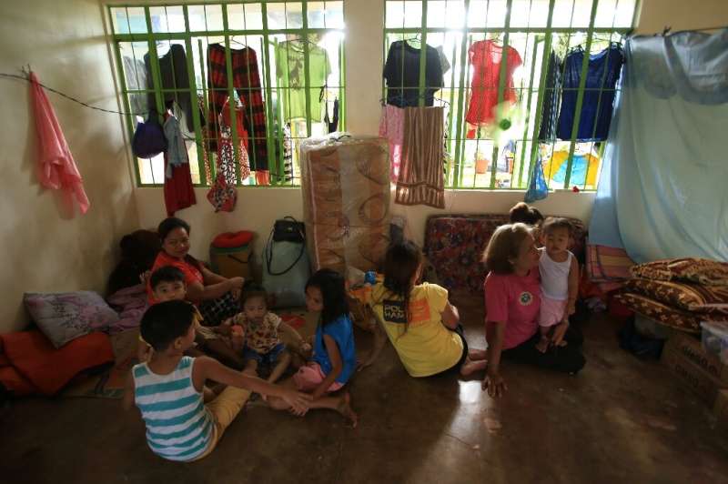Filipinos take shelter in an elementary school as volcanic activity increases at nearby Mount Mayon