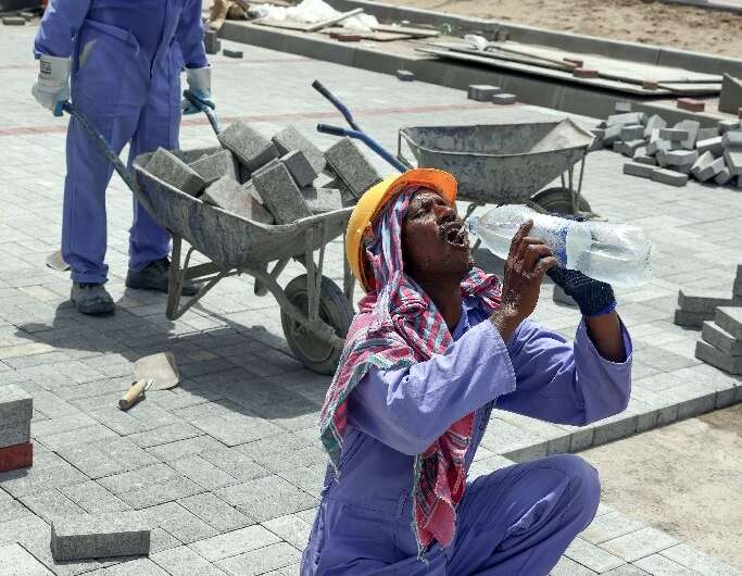 Foreign workers toil at a construction site in the Omani capital Muscat