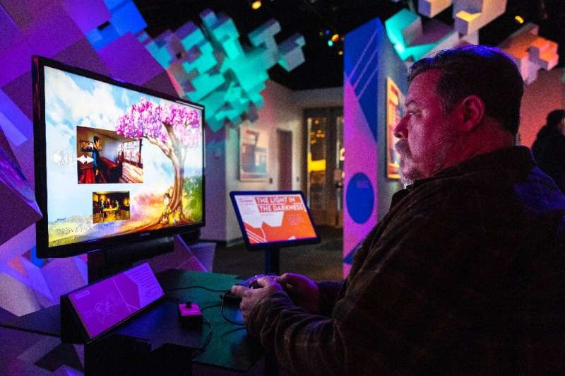 Gamer Stefan Montgomery plays 'The Light in the Darkness' at the Museum of Pop Culture in Seattle -- the game is available for p