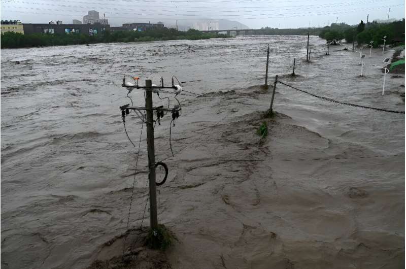 Heavy rains battered northern China on Monday, killing at least two people in Beijing