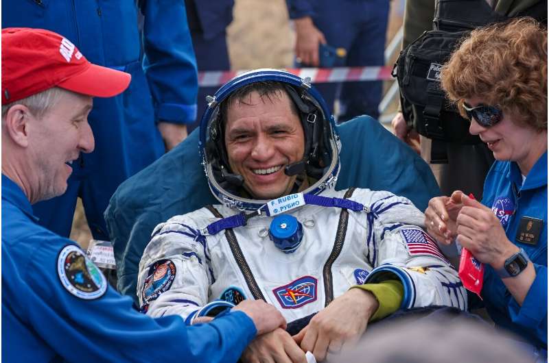 In this handout photograph taken and released by Roscosmos on September 27, 2023, Expedition 69 NASA astronaut Frank Rubio is helped by specialists after his landing in the Soyuz MS-23 capsule in a remote area near the town of Dzhezkazgan, Kazakhstan