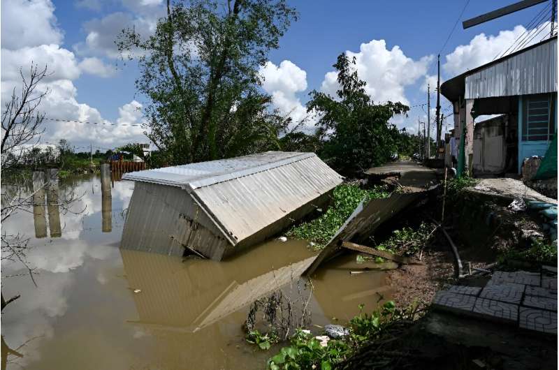 Le Thi Hong Mai's house collapsed into the Hau river due to erosion in southern Vietnam attributed to sand dredging