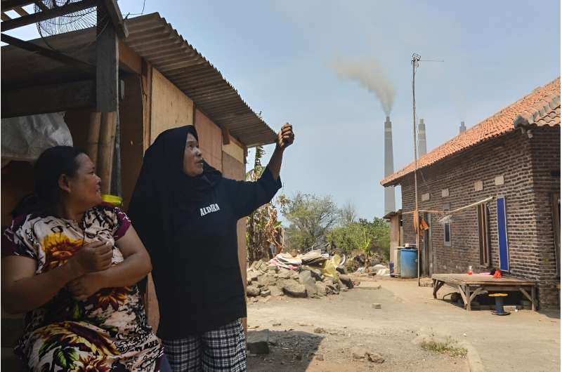 Local residents talk about air pollution during an interview with AFP near the Suralaya coal-fired power plant in Cilegon, in Indonesia's Banten province