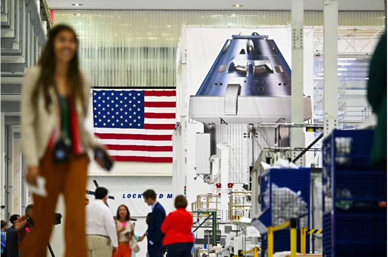 Officials and media personnel are seen inside the Operations and Checkout Building (O&amp;C) at the Kennedy Space Center in Cape