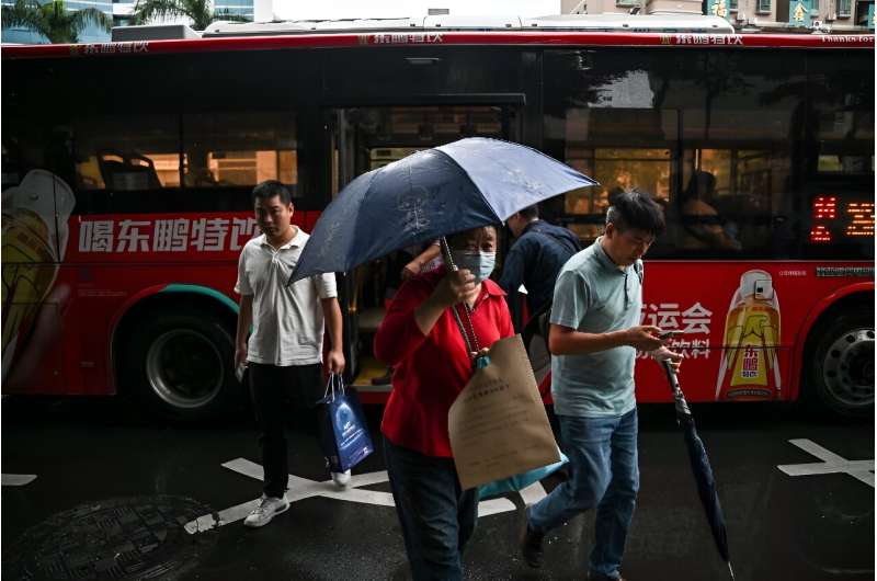 On a rainy afternoon in Shenzhen, damp passengers jostle their way onto the megacity's buses, the quiet foot soldiers of an electric revolution