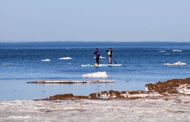 Paddleboarders brave the icy waters of Lake Superior