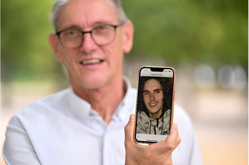 Paul Raoult, the father of Sebastien Raoult, shows a picture of his son on his phone