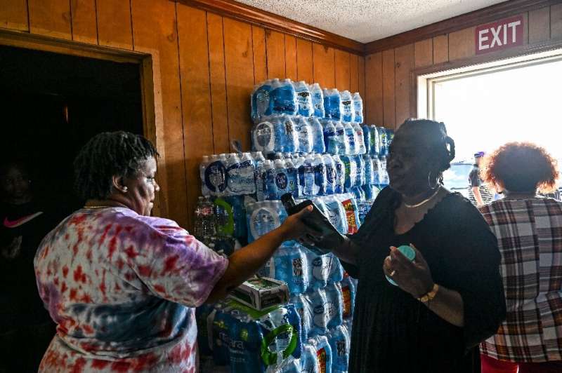 People collect essentials at a relief center in Silver City, Mississippi in the aftermath of a deadly tornado