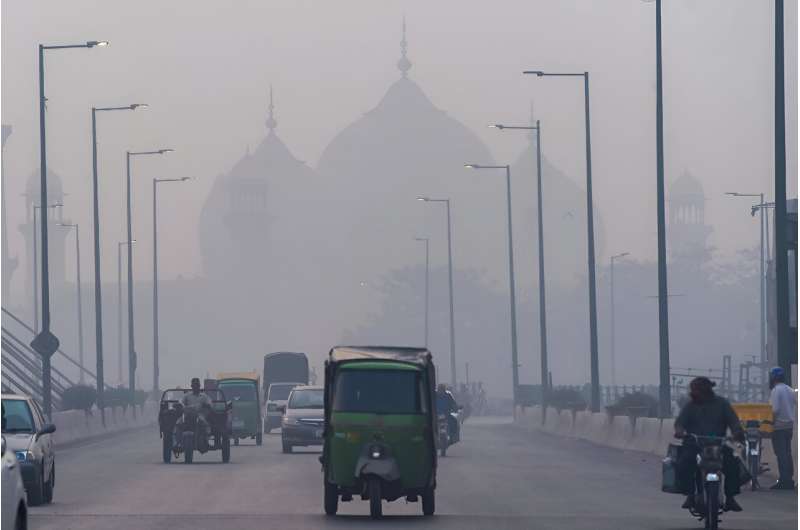 People commute along a street amid smoggy conditions in Lahore, Pakistan; South Asia is the global epicenter of an air pollution