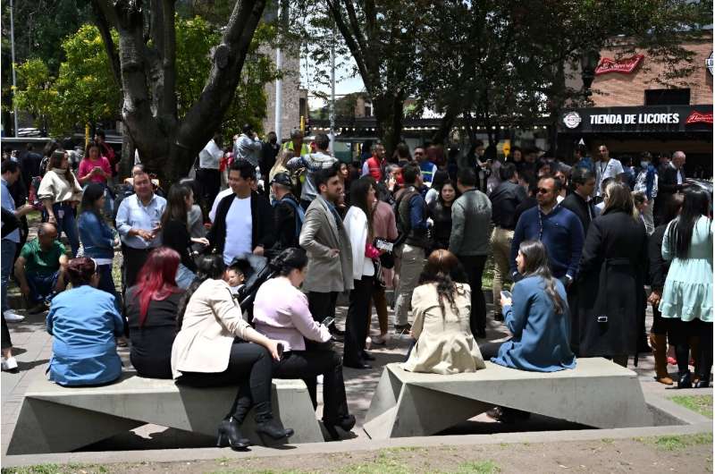 People mill about on the streets after an earthquake in Bogota, on August 17, 2023
