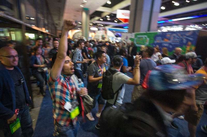 People rush into an exhibit hall on opening day of the Electronic Entertainment Expo (E3) at the Los Angeles Convention Center i