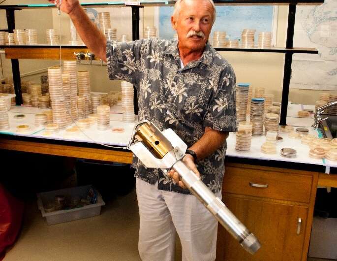 Professor William Fenical with a tool used to collect ocean sediment