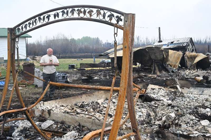 Property owner Adam Norris surveys the damage from wildfires at his home in Drayton Valley, Alberta, Canada