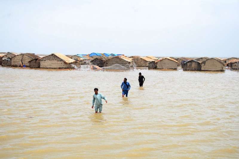 Resident wade through water as Cyclone Biparjoy impacts Pakistan's Sindh province