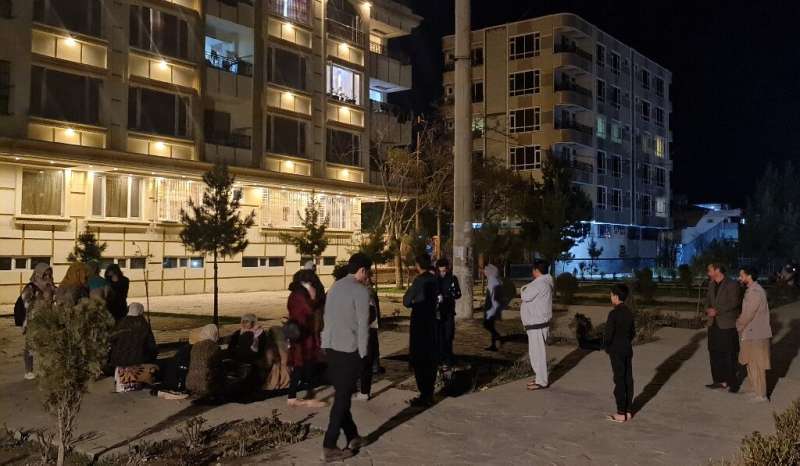 Residents of an apartment block in the Afghan capital gather outside their home after the quake