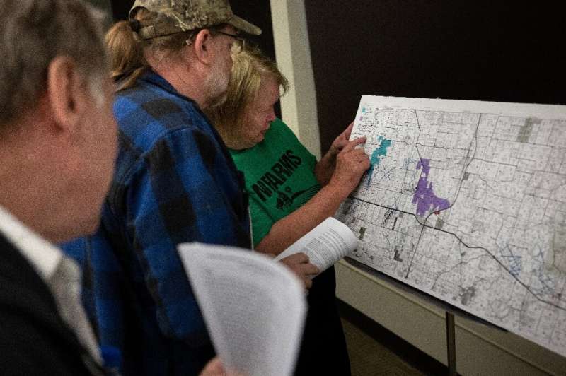 Residents of central Missouri study a land registry map to see the location of proposed  solar farms