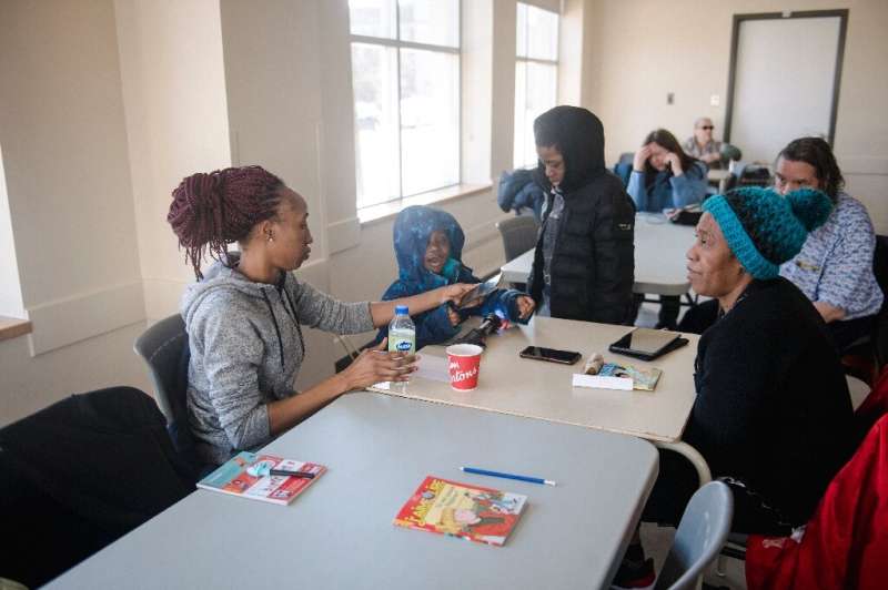 Rosalie Gouba warms up with her mother (right) and two children at a community center in the Verdun neighborhood of Montreal, Ca