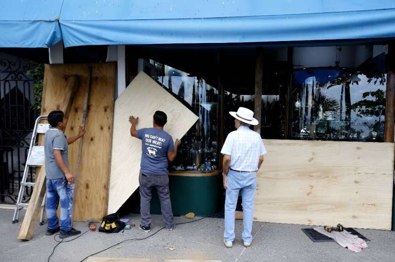 Shopkeepers in Mexico's beachside city of Puerto Vallarta board up windows as Hurricane Lidia approaches