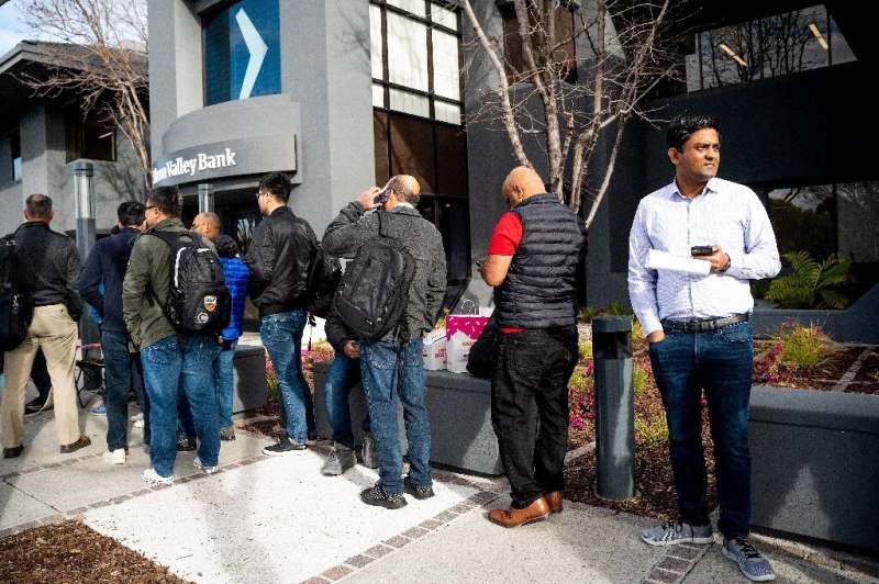 Silicon Valley Bank customers wait in line at SVB’s headquarters in Santa Clara, California on March 13, 2023