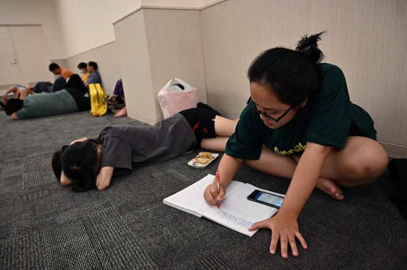 Student Nguyen Minh Thu works on an assignment in a room in a mall set aside for people seeking to escape from high outdoor temp