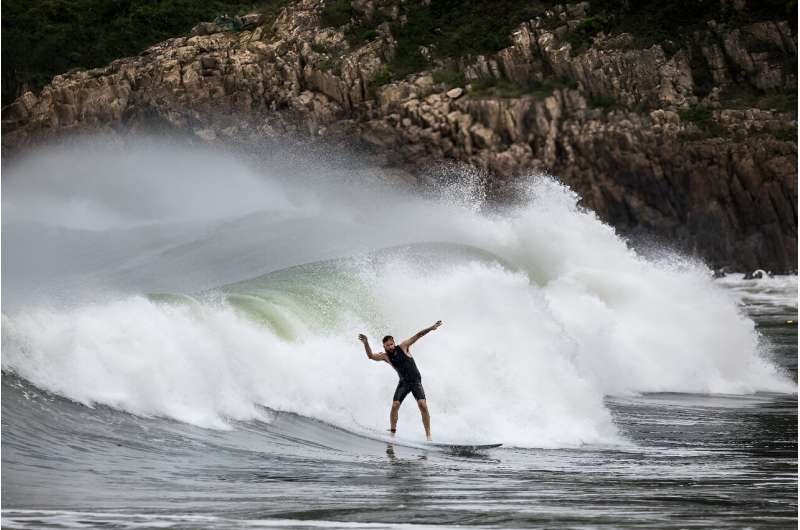 Surfers took advantage of the high winds and tackled huge waves generated by the coming typhoon at Hong Kong's beaches