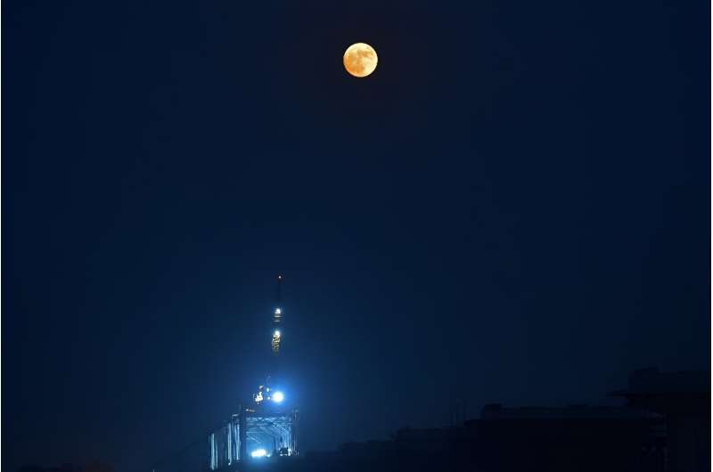 The Blue supermoon rises over the river Ganges, in Prayagraj on August 30, 2023.