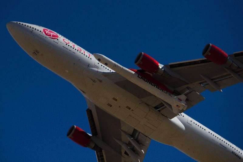 The Virgin Orbit 'Cosmic Girl' -- a modified Boeing 747 carrying a LauncherOne rocket under its wing -- takes off from Mojave Ai