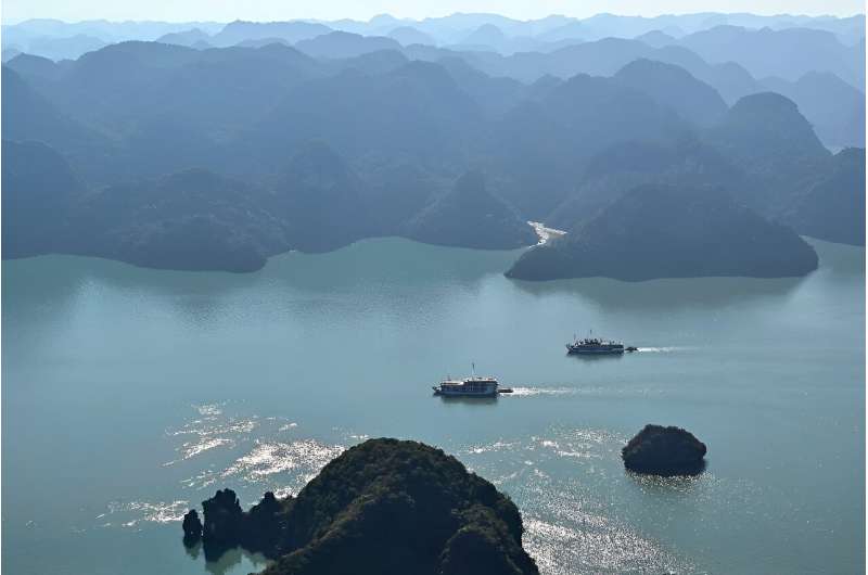 This aerial photo taken from a seaplane shows tourist boats sailing on the waters of Ha Long Bay on December 28