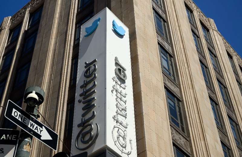 Twitter's sign is seen partially removed after San Francisco Police paused its removal at the company's headquarters