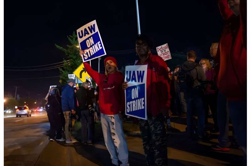 UAW members picket outside of the Local 900 headquarters across the street from a Ford assembly plant in Wayne, Michigan on Sept