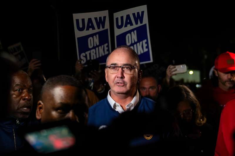 UAW President Shawn Fain speaks with members of the media and the union outside of the Local 900 headquarters in Wayne, Michigan