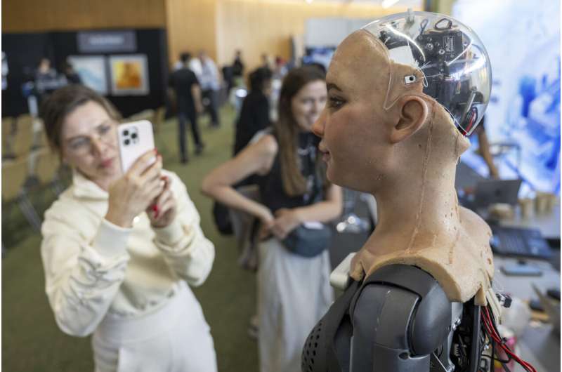 UN tech agency rolls out human-looking robots for questions at a Geneva news conference