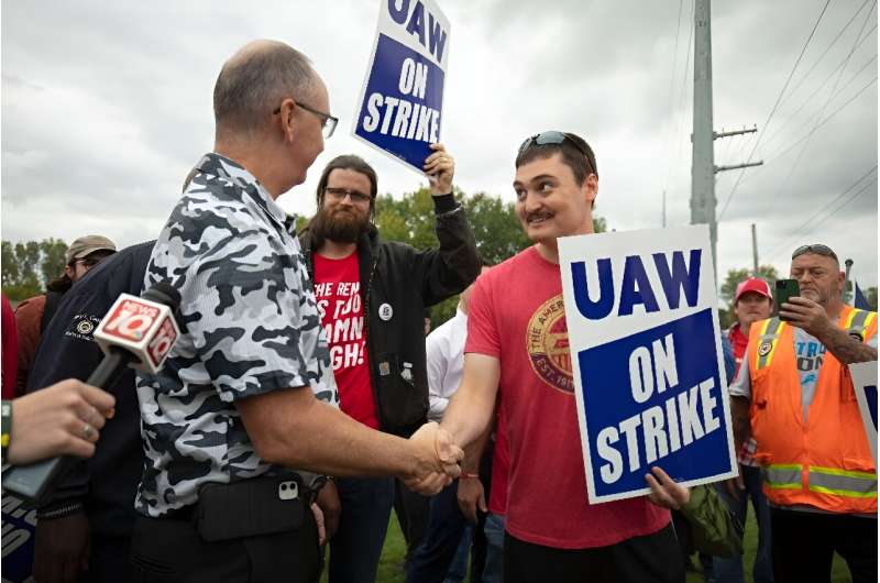 United Auto Workers President Shawn Fain greets UAW members as they strike the General Motors Lansing Delta Assembly Plant in September 2023