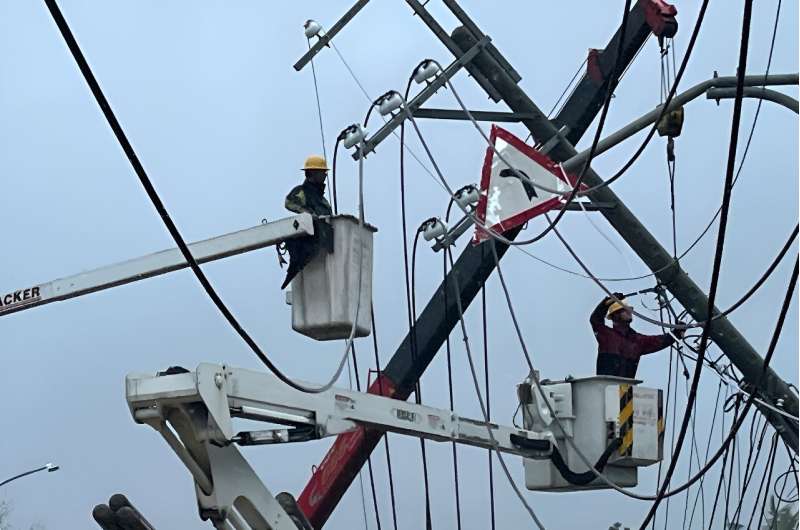 Utility workers try to repair power lines downed by the high winds from Typhoon Koinu in Taiwan on October 5, 2023