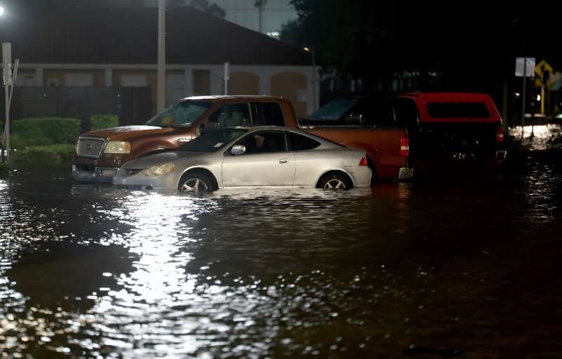 Vehicles sit in a street flooded by Hurricane Idalia on August 30, 2023 in St. Petersburg, Florida