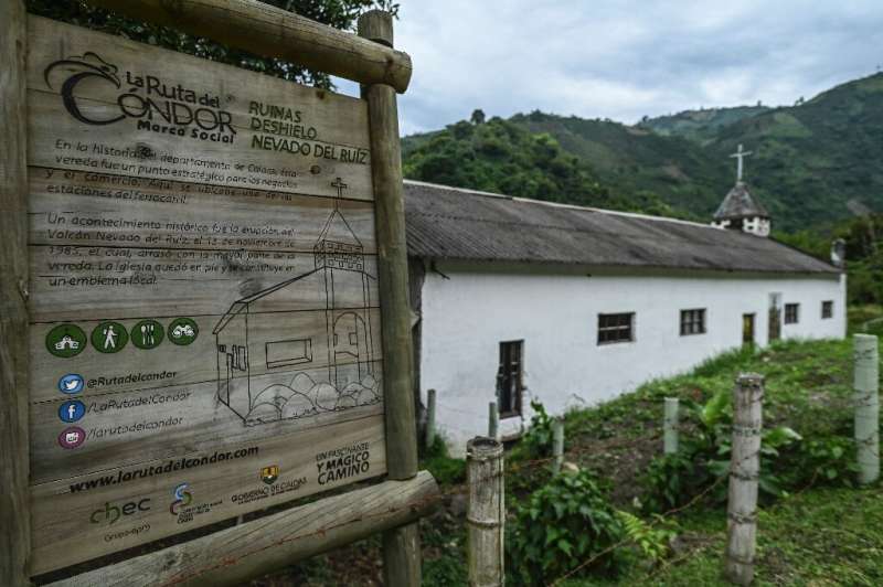 View of a sign telling the story of the church of the Rio Calro village which survived the last major eruption of the Nevado del