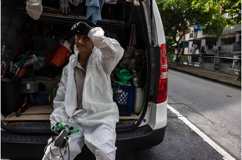 Wah, a 63-year-old pest control worker, told AFP it 'feels like it's raining' inside the protective suit his job requires