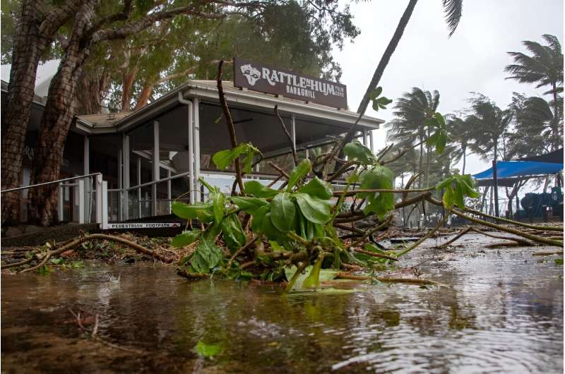 A bar restaurant is seen past fallen branches in Palm Cove as Cyclone Jasper approaches landfall near Cairns in far north Queensland on December 13, 2023.