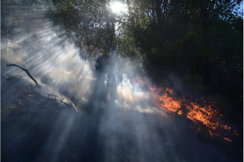 A firefighter works to extinguish a wildfire in Keratea, near Athens, on the weekend